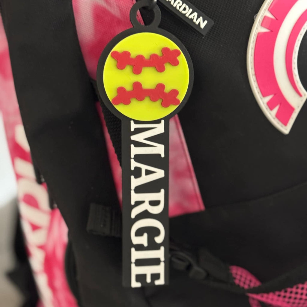 Custom softball bag tag attached to a backpack