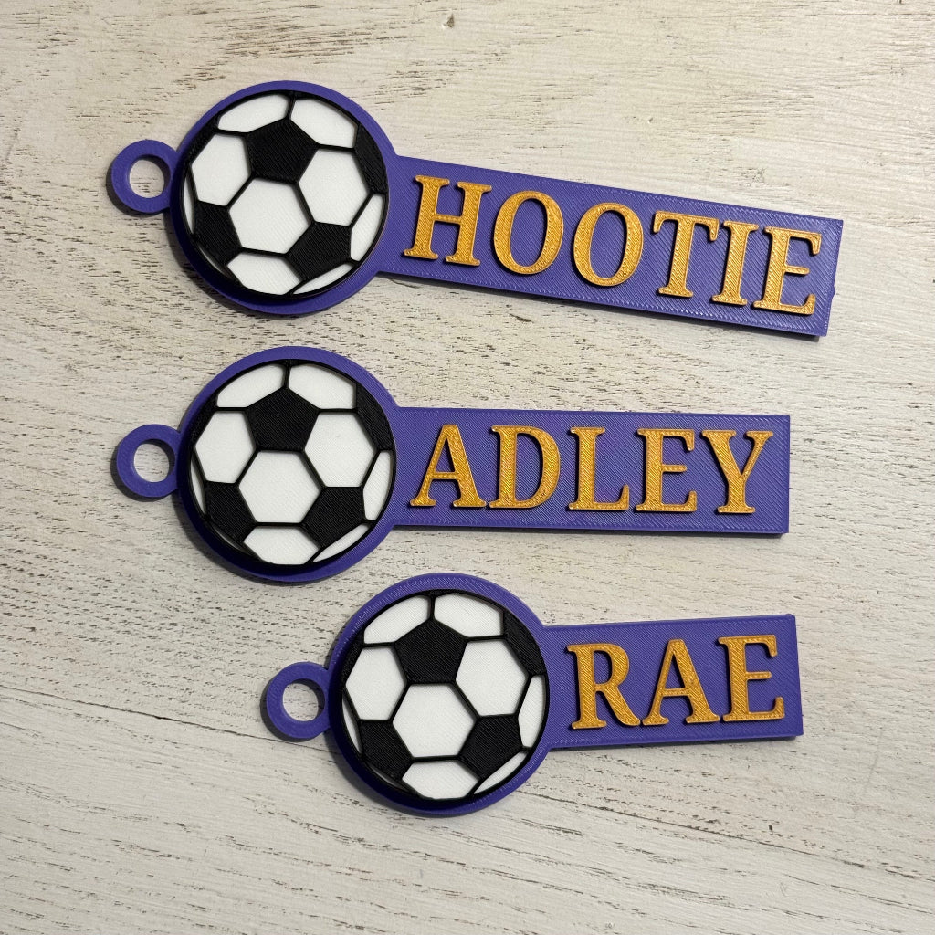 Example of custom sports bag tags with soccer in purple and gold