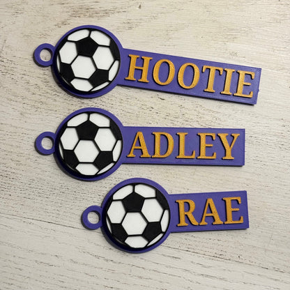 Example of custom sports bag tags with soccer in purple and gold