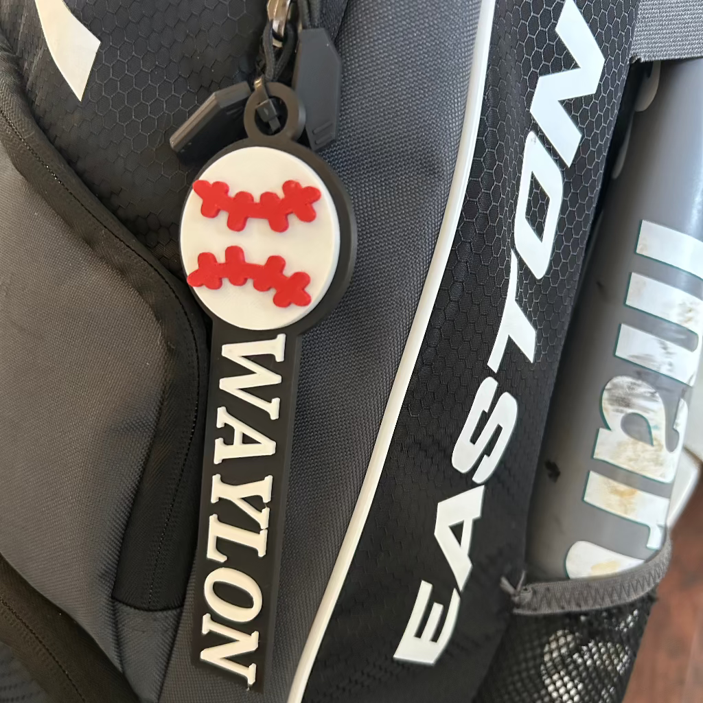 Customer photo of their personalized baseball bag tag on a backpack