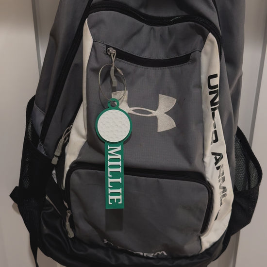 Example of custom golf bag tag attached to a backpack