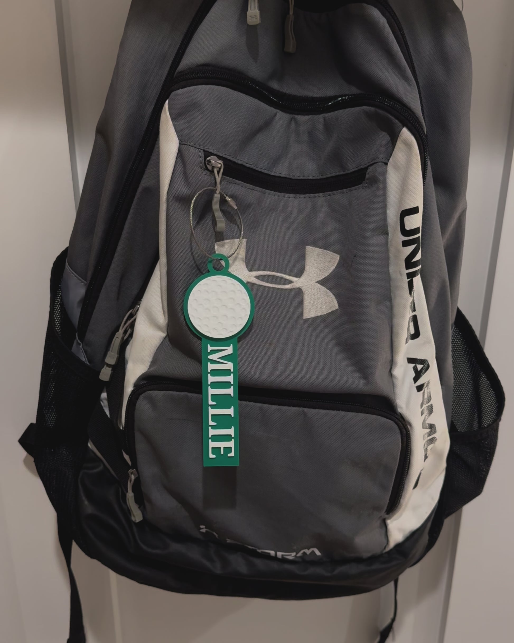 Example of custom golf bag tag attached to a backpack