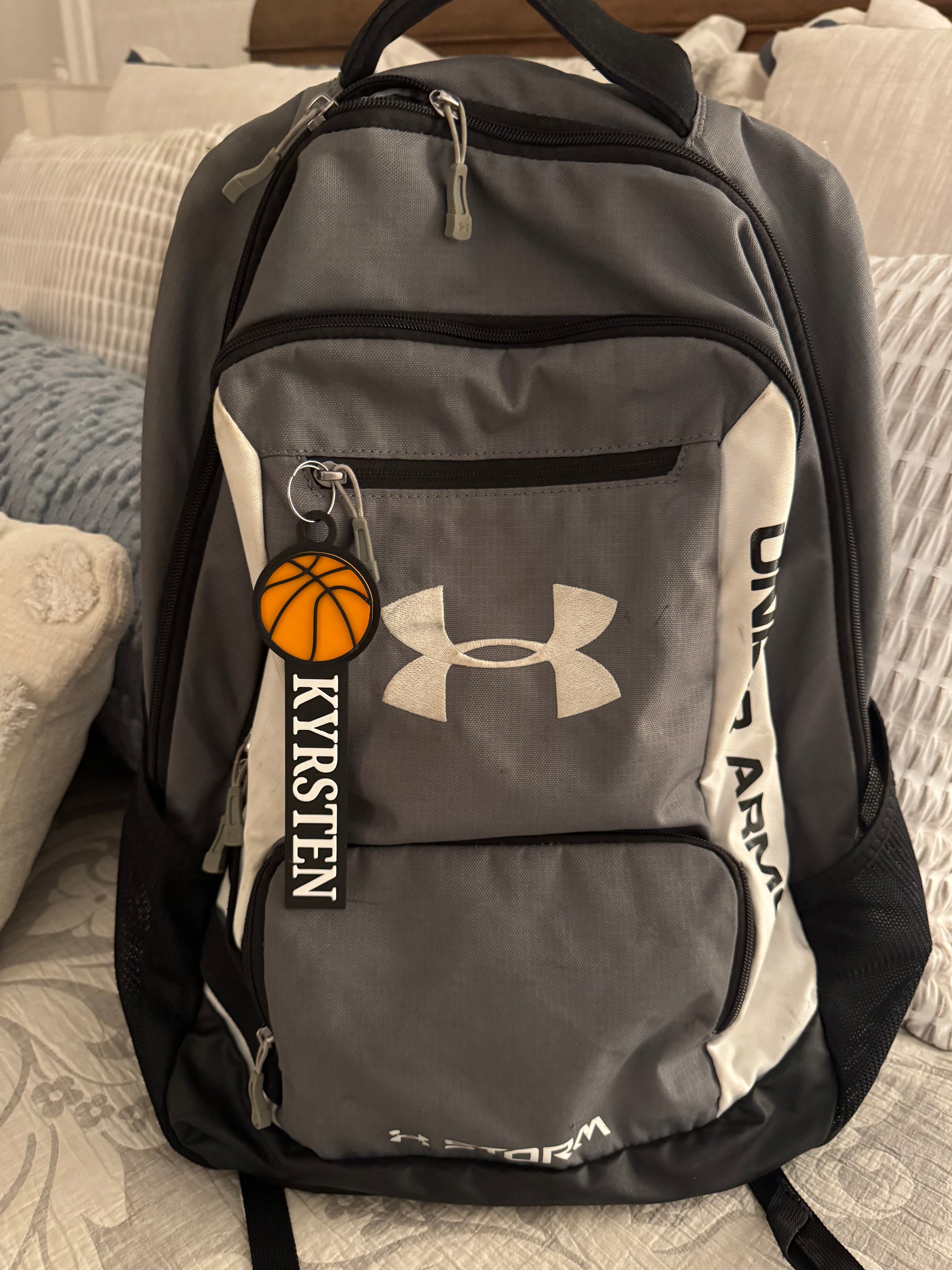 Example of the custom basketball bag tag with a girls name attached to a backpack