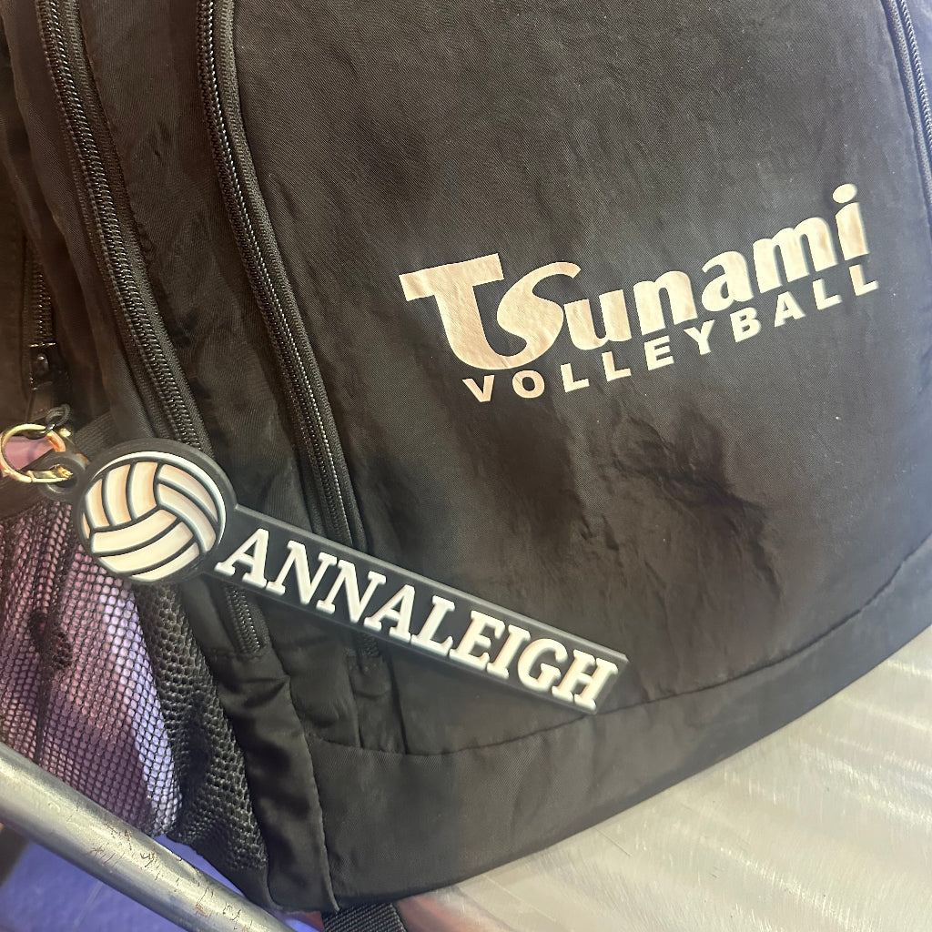 Custom volleyball bag tag attached to a backpack