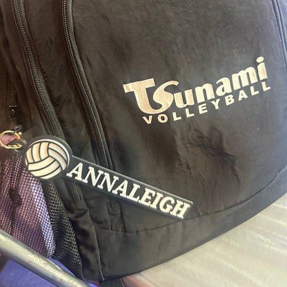 Custom volleyball bag tag attached to a backpack